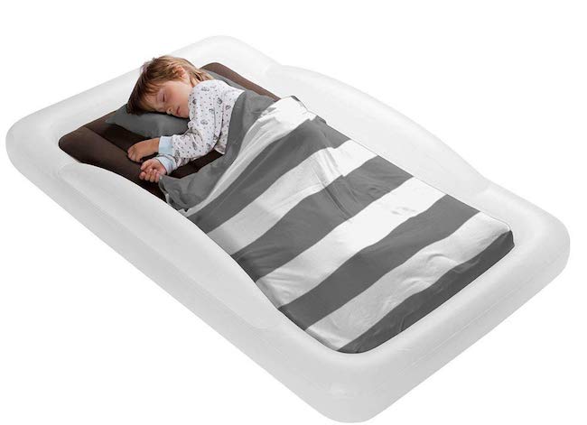 Child sleeping on The Shrunks toddler travel bed.