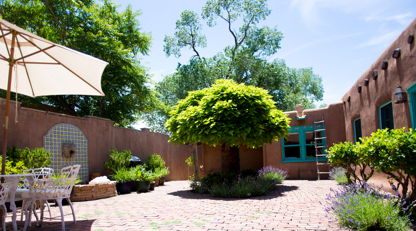 A Spanish-style back patio made of brick and decorative tiles.