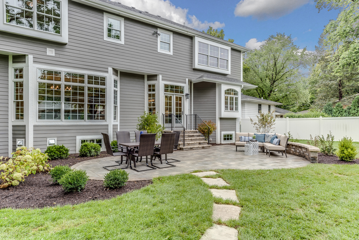 A gray home with a paver patio.