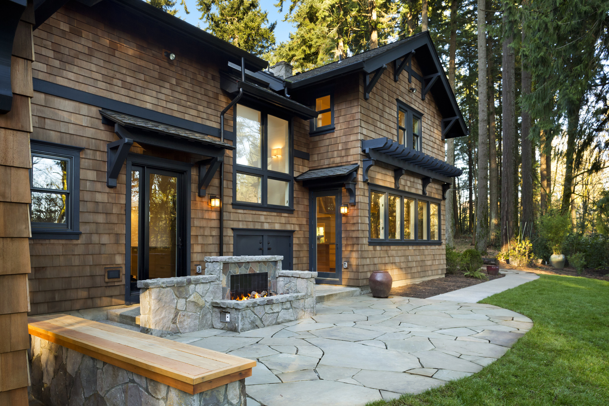 A large home with a modern stone fireplace.