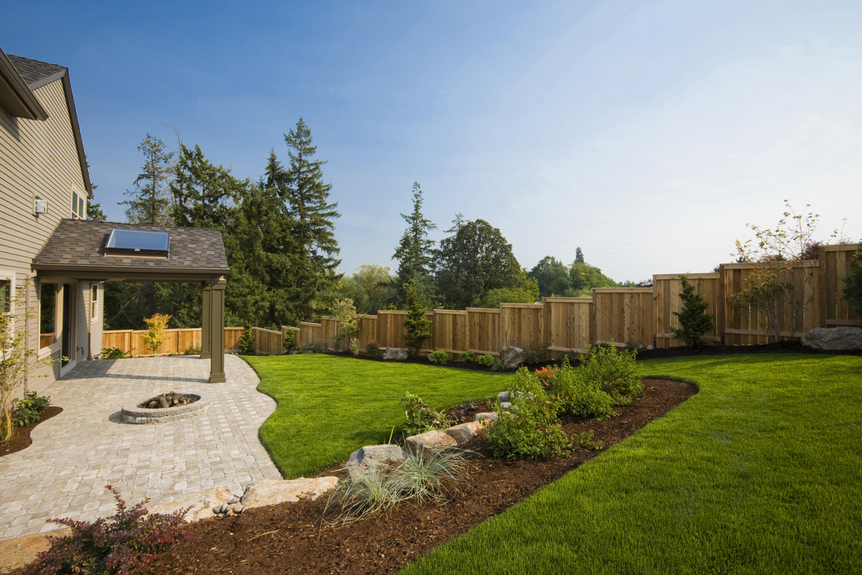 A well landscaped backyard with a slope.