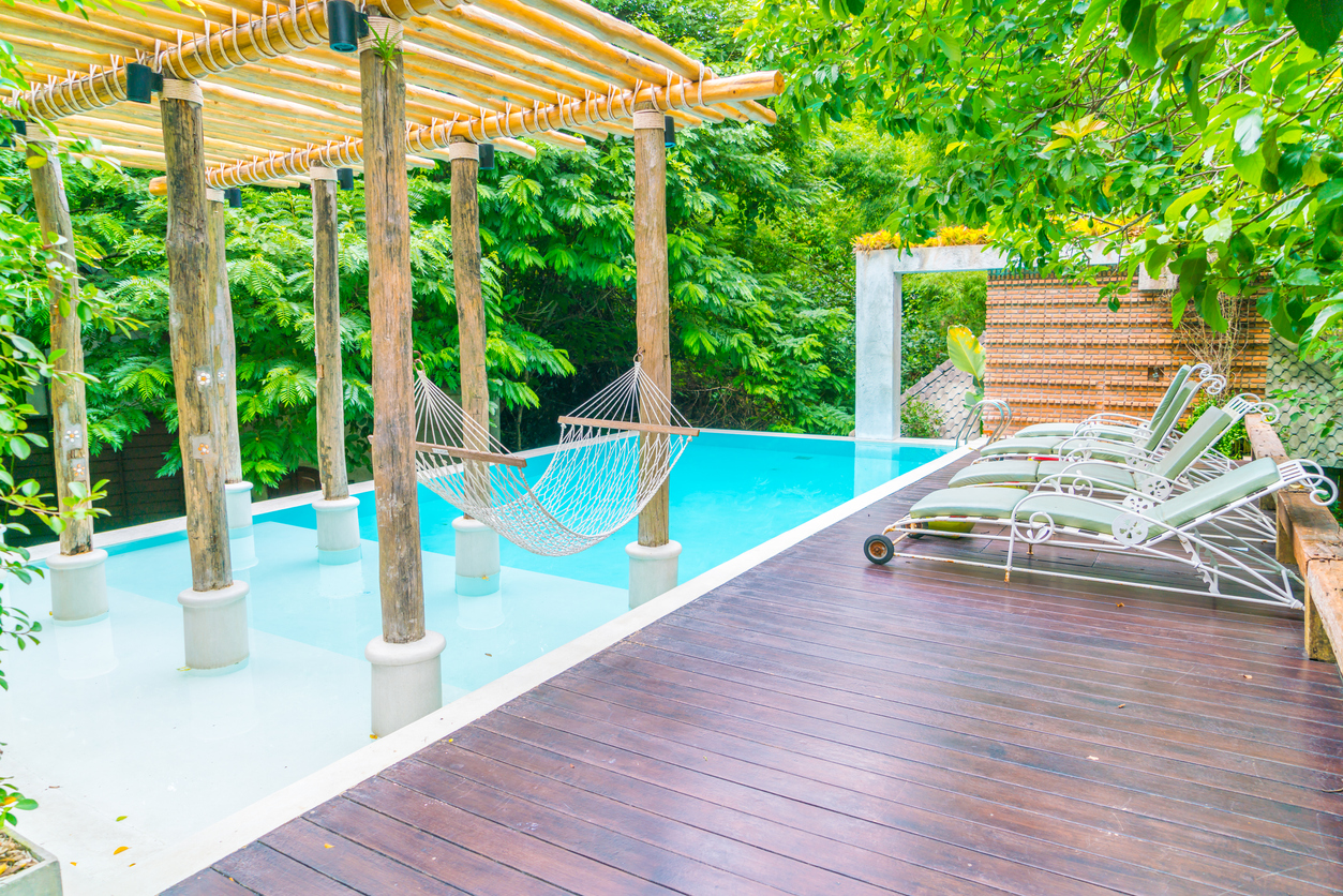 Deck chairs by a small plunge pool, all with a tropical atmosphere.