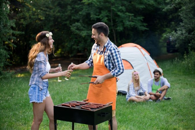 People at a picnic with different grilling options