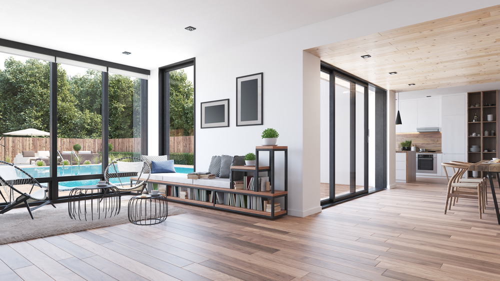 Sliding glass doors on a modern style home with a pool visible outside and hardwood floors on the inside.