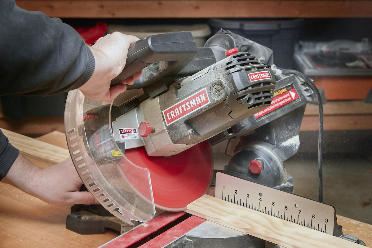 Making a bevel cut with a miter saw.