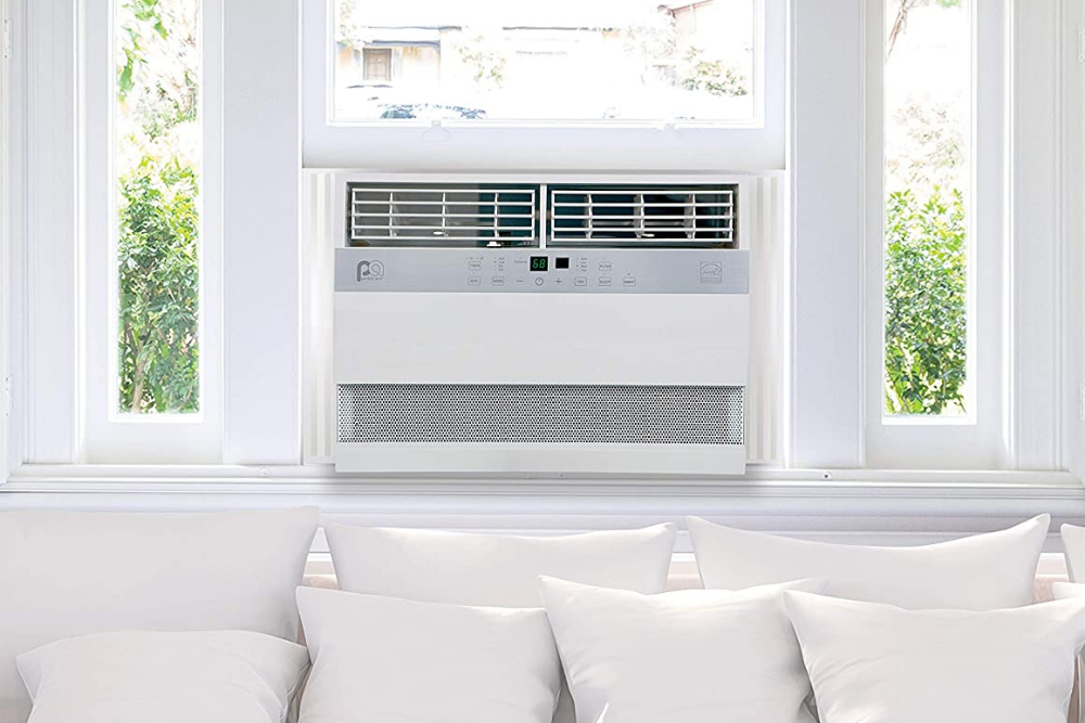 One of the Best Window Air Conditioners installed in white window above white couch