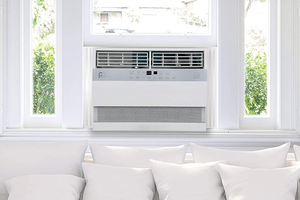One of the Best Window Air Conditioners installed in white window above white couch