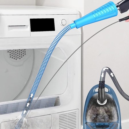  The Sealegend Vacuum Hose Dryer Vent Cleaner Kit hooked up to a vacuum and cleaning a dryer vent.