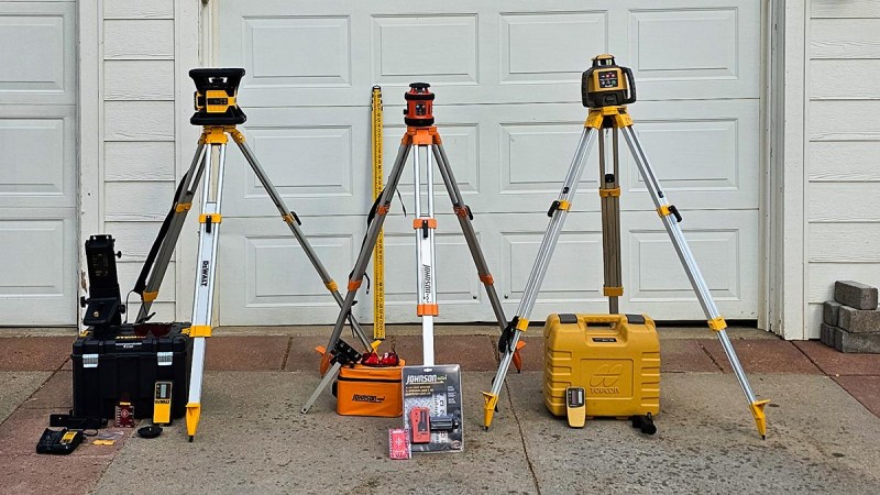 A group of the best rotary laser levels in front of a garage before testing.