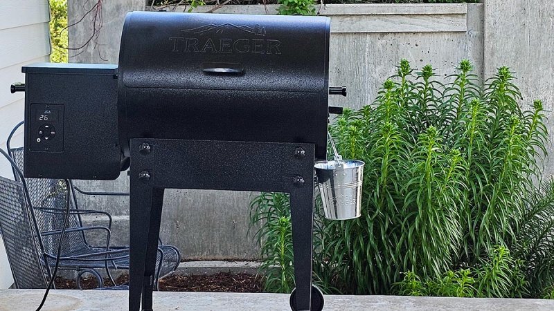 The Traeger Tailgater Portable Wood Pellet Grill set up on a patio for testing.