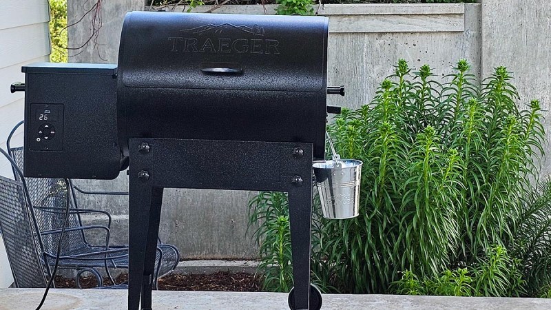 The Traeger Tailgater Portable Wood Pellet Grill set up on a patio for testing.