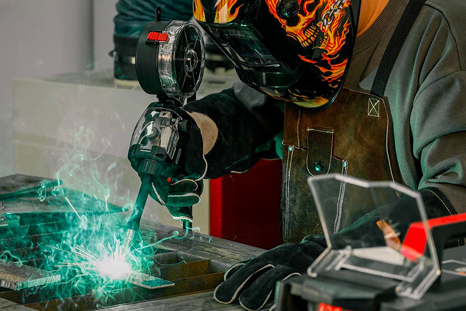 A close-up of a welder in a mask using the best welder for beginner option