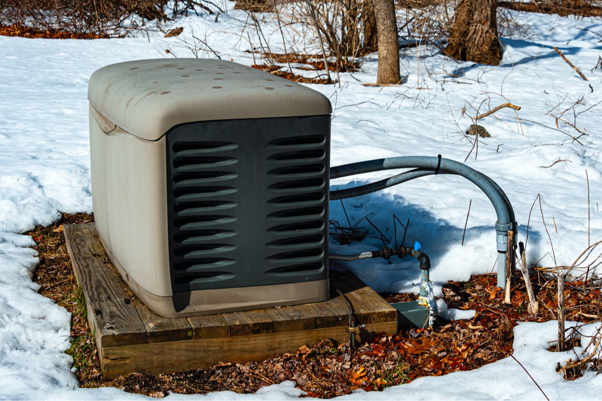 A whole house generator in the snow.