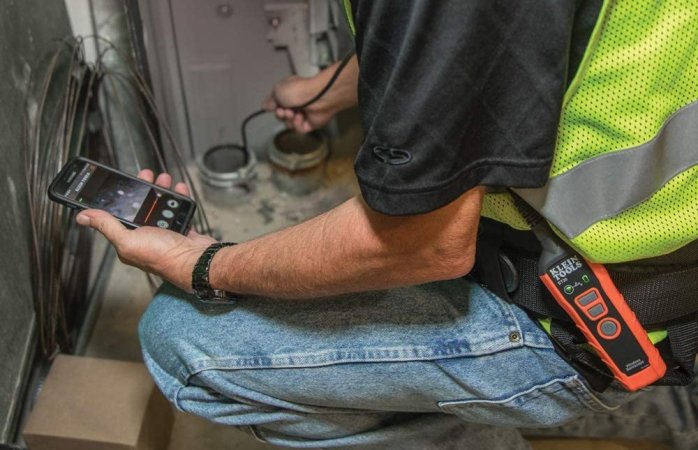 A person using the best borescope option to look inside two plumbing pipes.