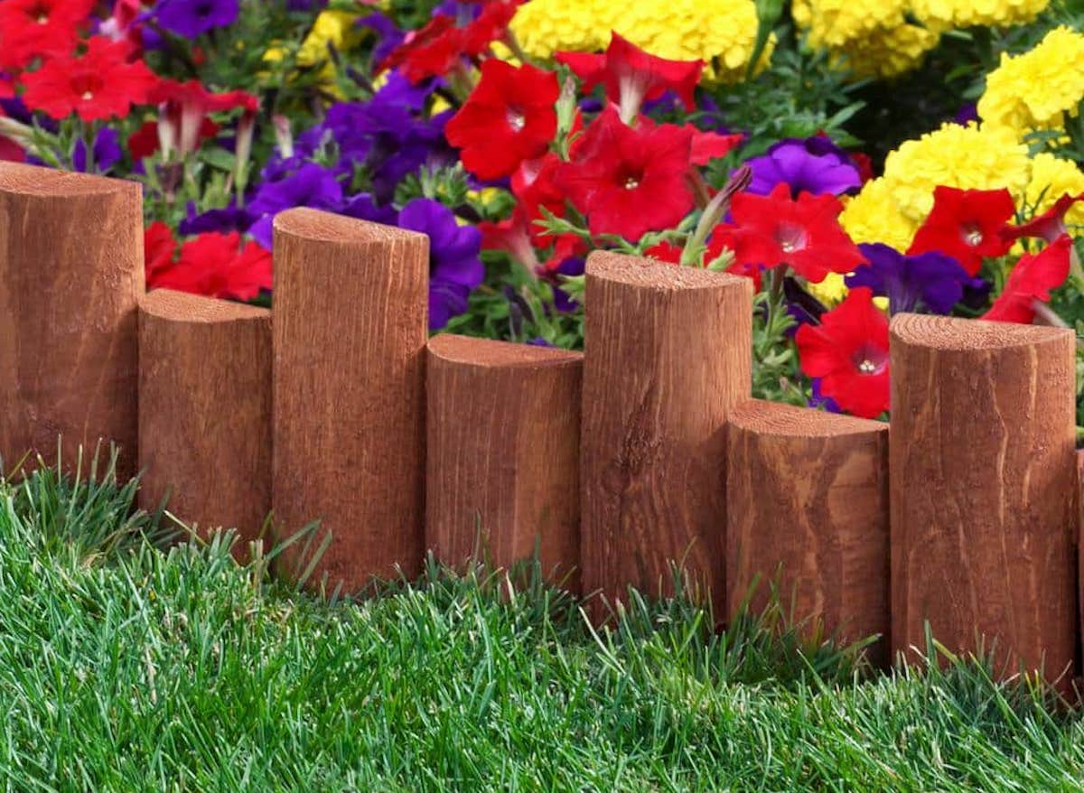 A flower bed surrounded by log-styled pavers.