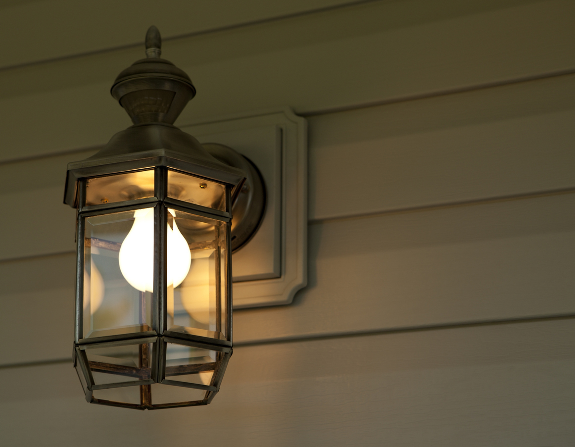 Exterior home porch light illuminated after dark