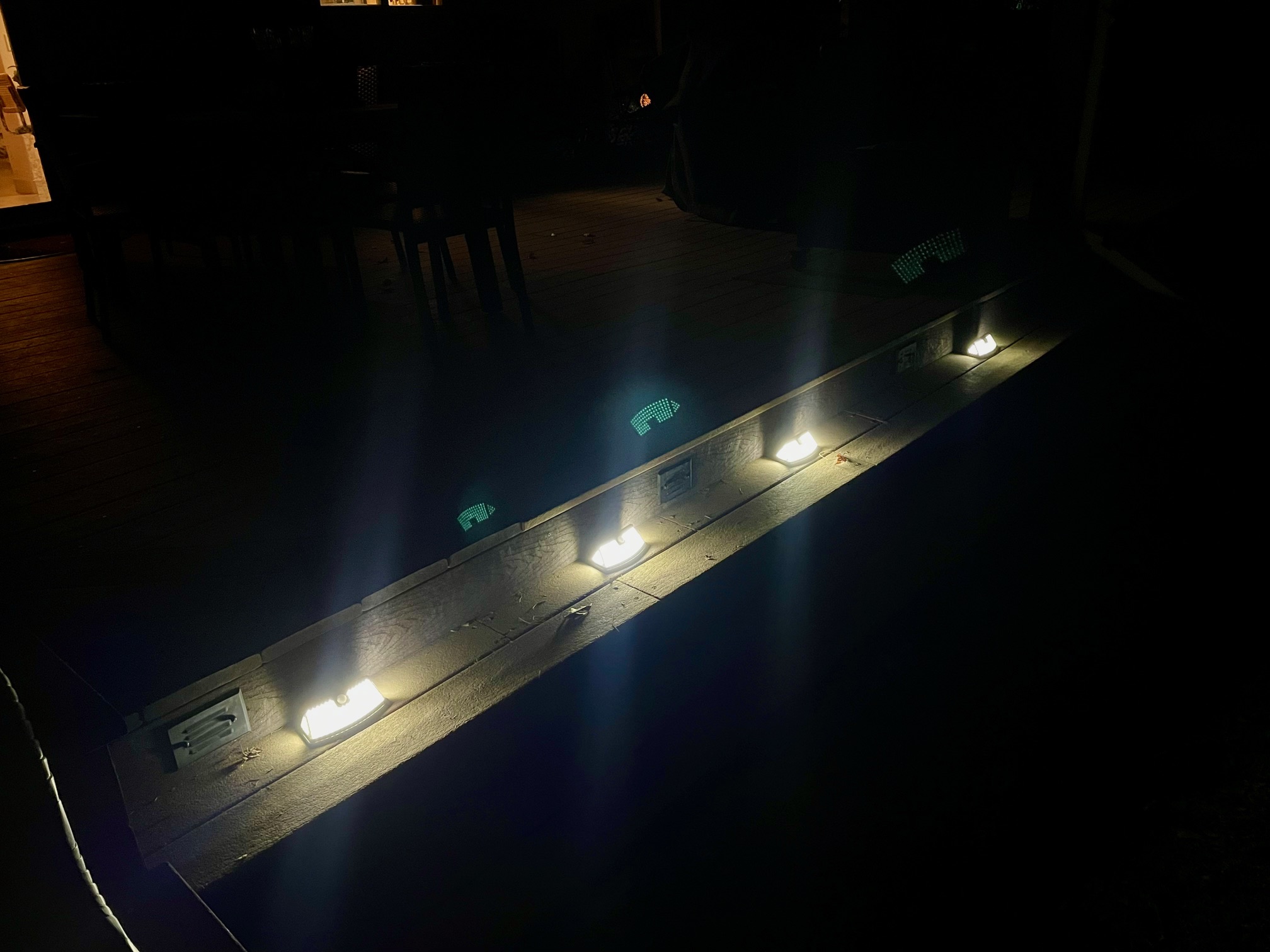 Aootek Solar Security Lights on deck steps lit up at night