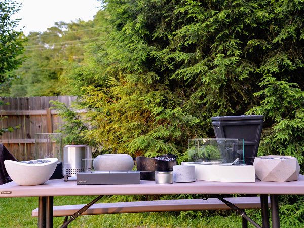 A group of the best tabletop fire pits on a picnic table before testing.