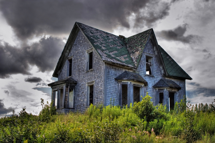 Haunted house styles old farmhouse in field under clouds