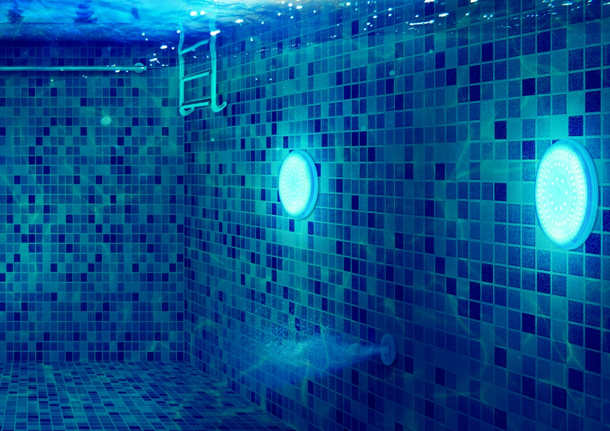 Pool lighting in a swimming pool with multi-toned blue tiles.