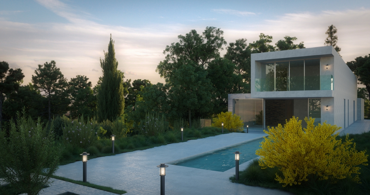 A white, modern home with a swimming pool with surrounding deck and walkway lit by path lights. 