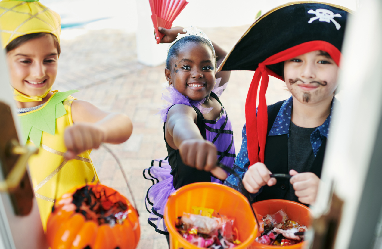 trick or treat kids in costumes getting candy