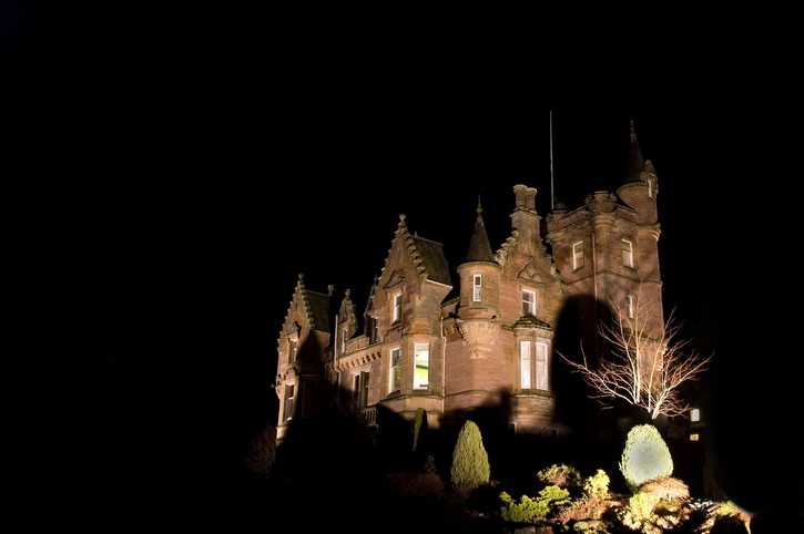 Haunted house styles antebellum mansion against night sky