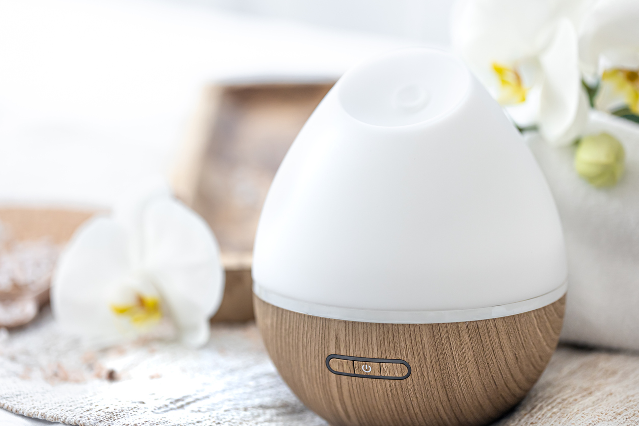 Closeup of a white diffuser with a wood base