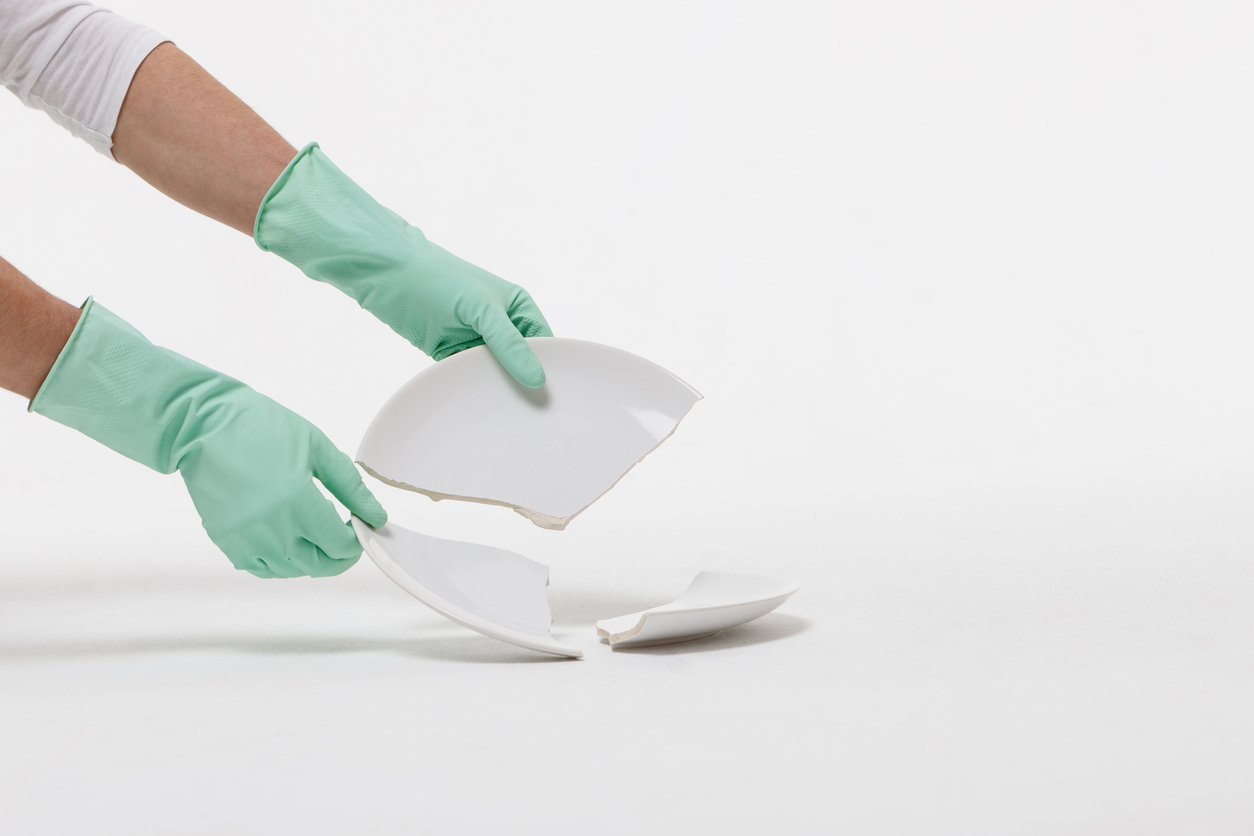 iStock-1297619392 work gloves cleaning up broken glass