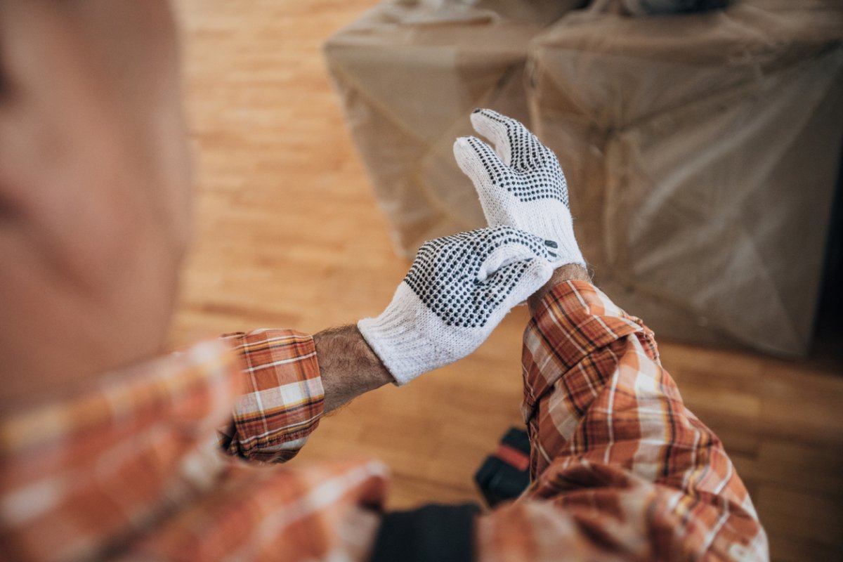 iStock-1313431708 work gloves putting on work gloves overhead shot