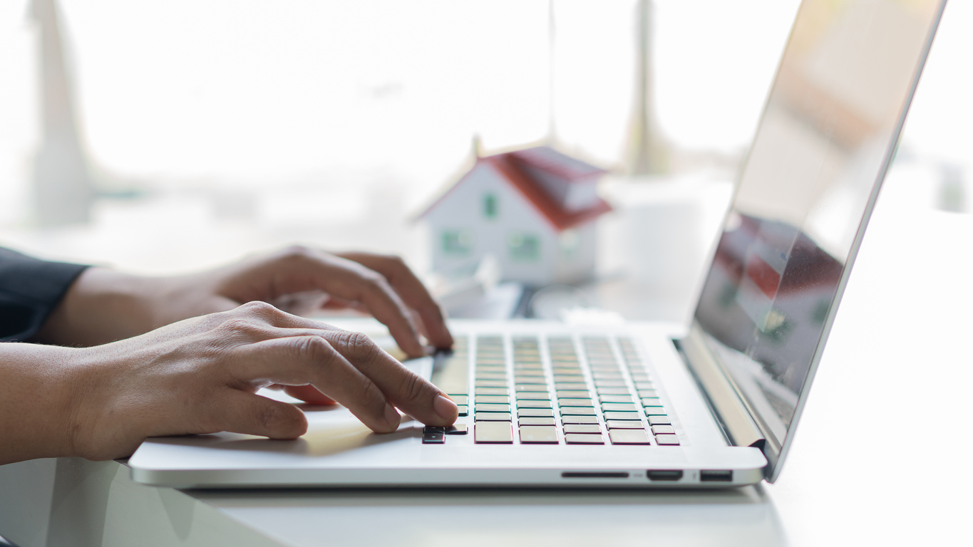 how much does a real estate agent make per sale hands typing on laptop