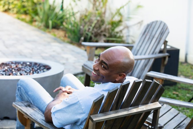 iStock-1390531105 outdoor living man relaxing in backyard