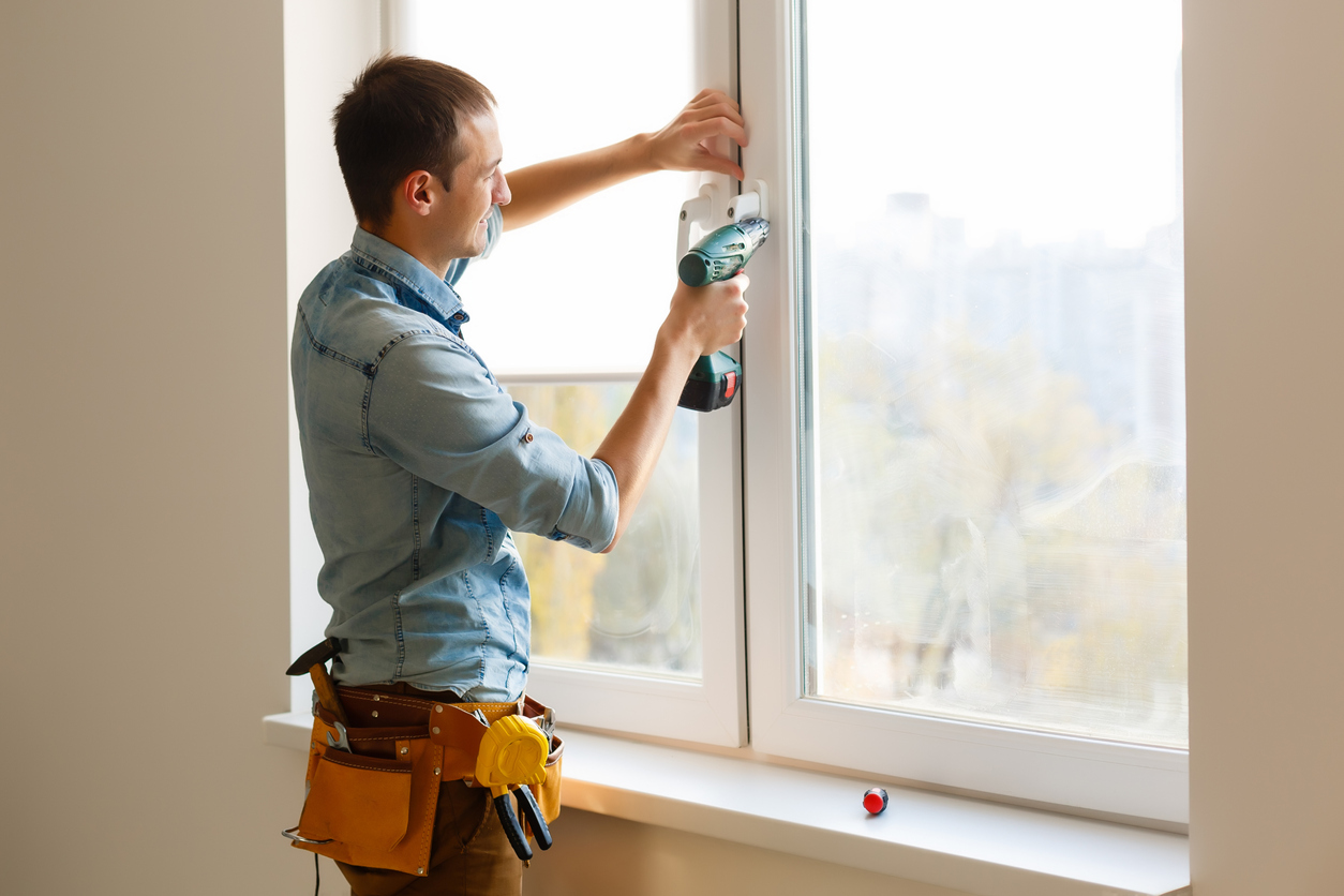 iStock-1186963326 rebates and tax credits man installing window.jpg