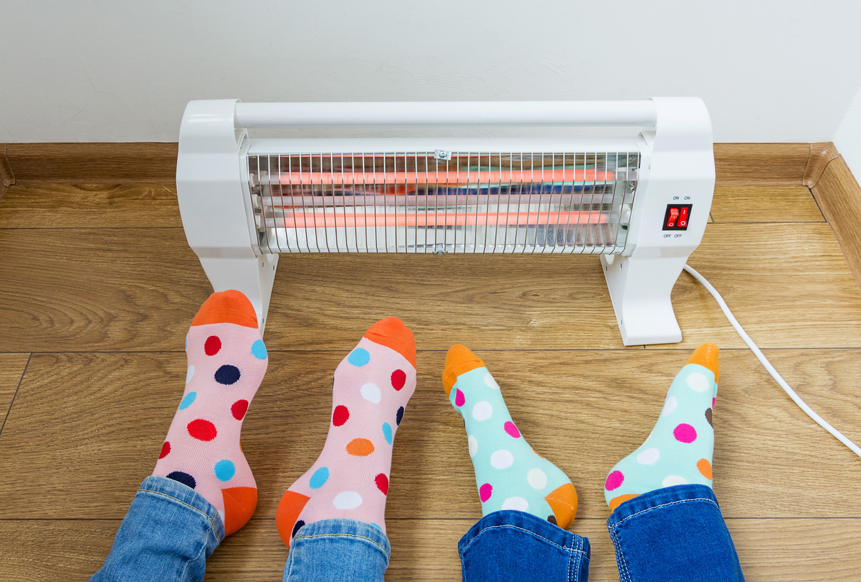 iStock-1291048000-how-much-does-it-cost-to-run-a-space-heater-feet-with-colorful-socks-by-infrared-heater.jpg