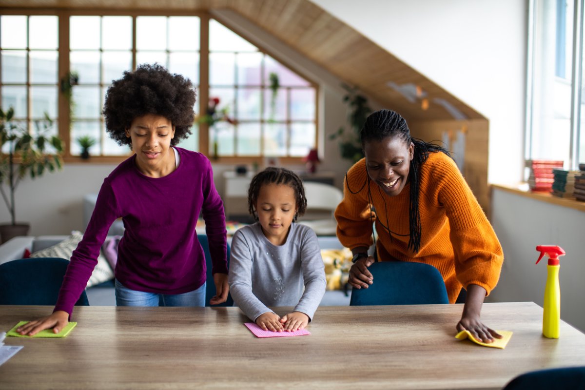 iStock-1303676807 cleaning resolutions family washing dining room table together.jpg