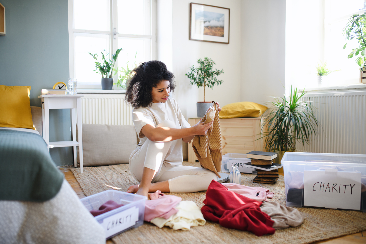 iStock-1304554687 must dos January Woman Sorting Wardrobe into keep and charity.jpg