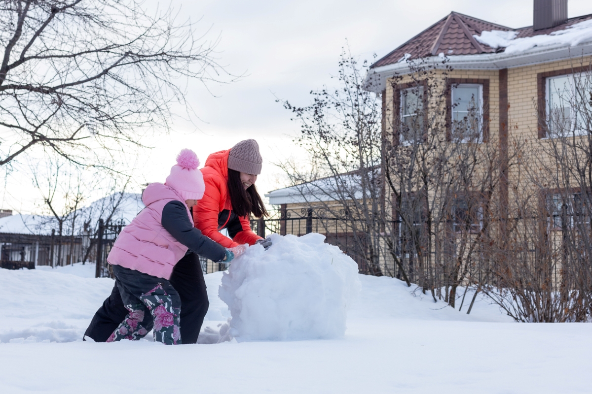 how to remove snow from a driveway without a shovel - people rolling snowball