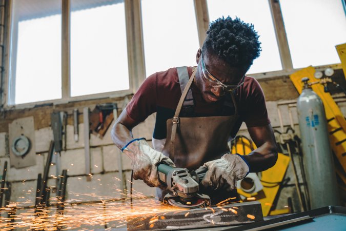 types of welds - man grinding down weld