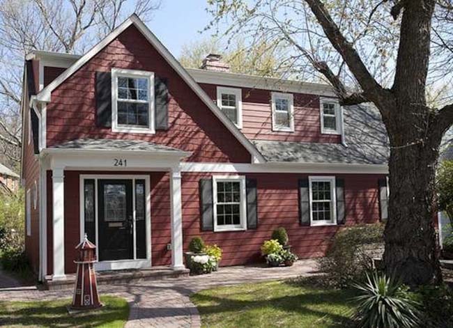 A red house with black trim on the windows.