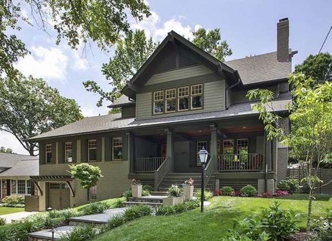 An olive green craftsmen home with a front porch.