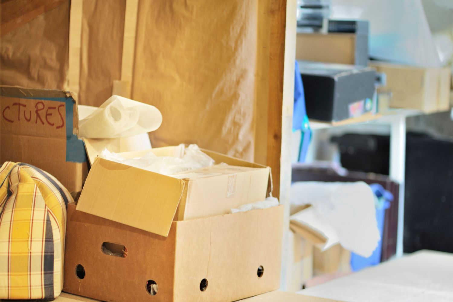 A close up of cardboard boxes full of personal items. 