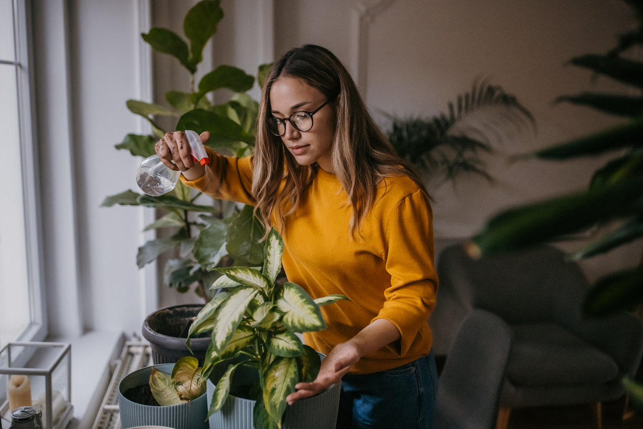 iStock-1360153618 how to improve your life woman watering house plants