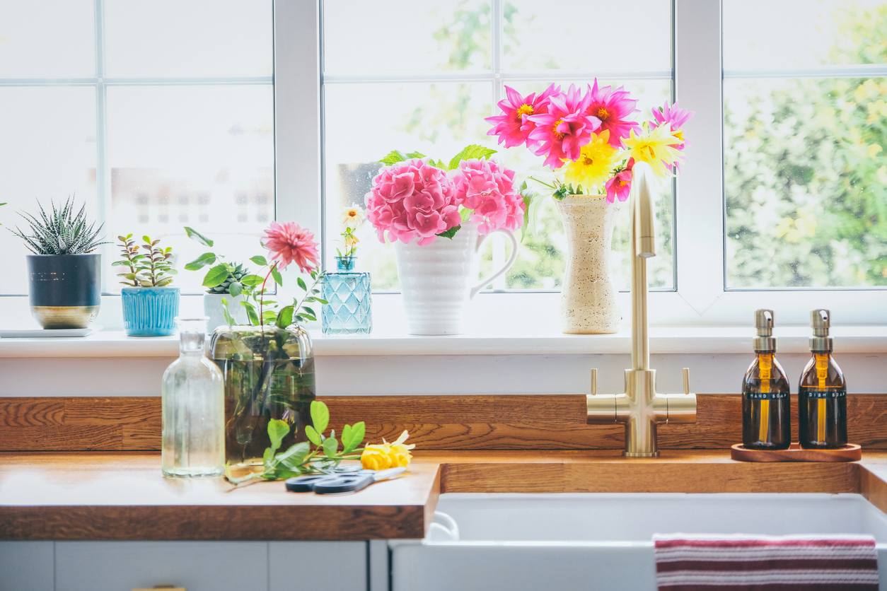 iStock-1420776083 cut flower garden bouquets of summer flowers in the window.jpg