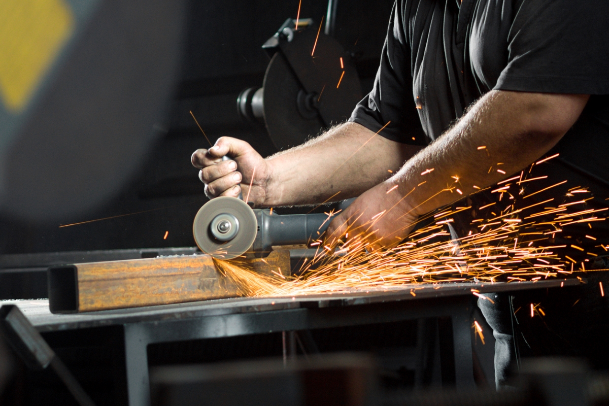 most dangerous power tools - hands holding angle grinder with sparks