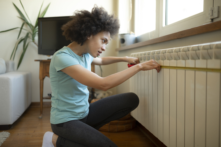 bob-vila-editors-projects-2023-woman-measurng-wall-for-project