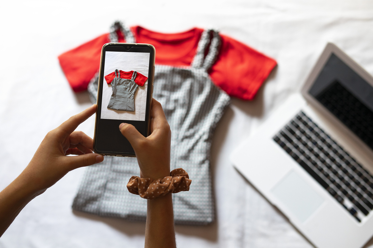 iStock-1254587682 craigslist alternatives Woman taking a photo of an article of clothing to sell online