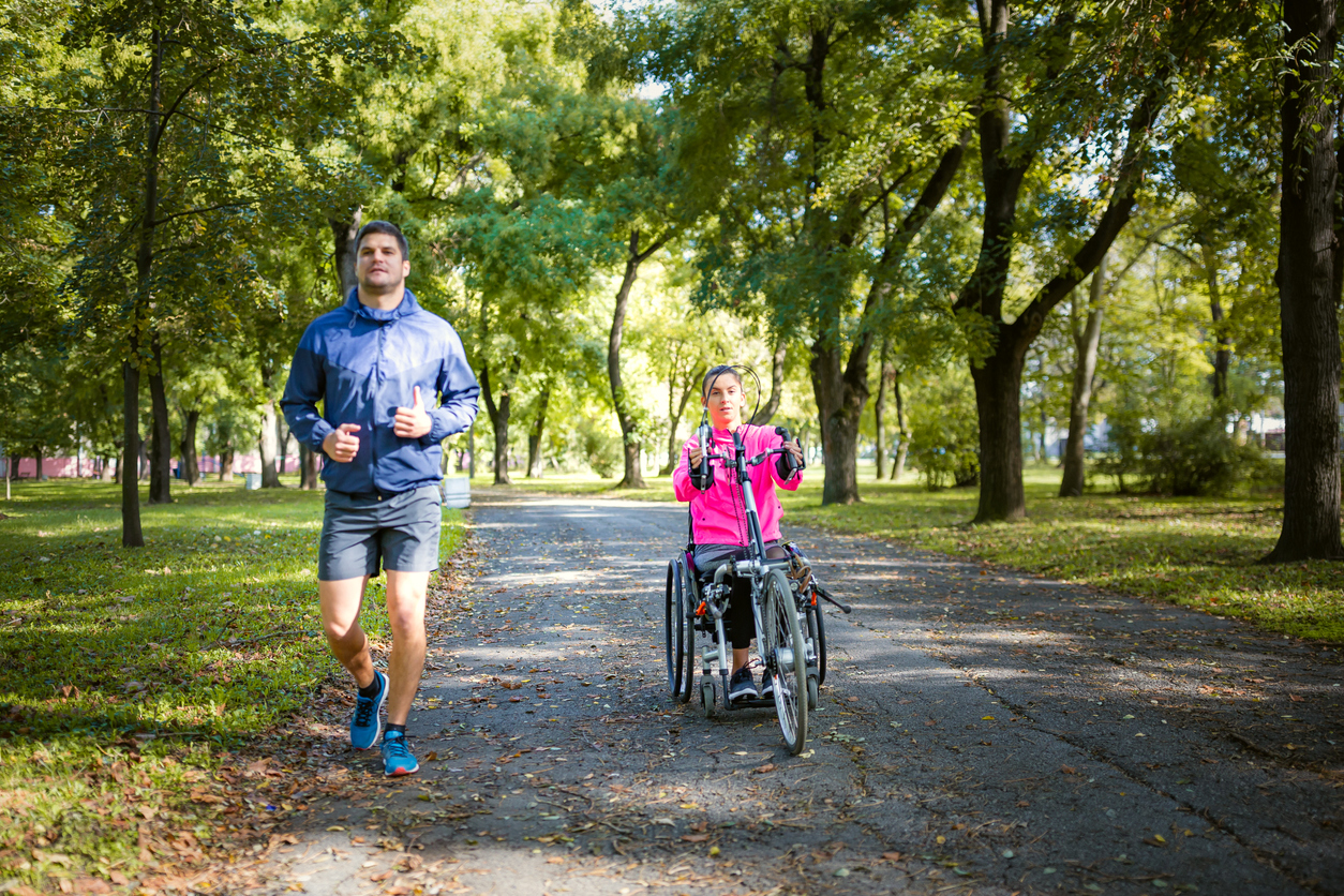 iStock-1286515623 master planned community Female wheelchair athlete having sport activity outdoors with her boyfriend