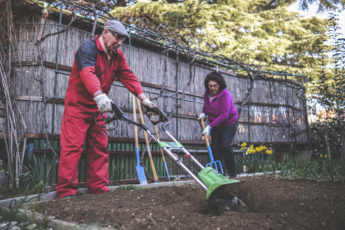 how to till a garden - using a rototiller and pitchfork to till soil in garden plot