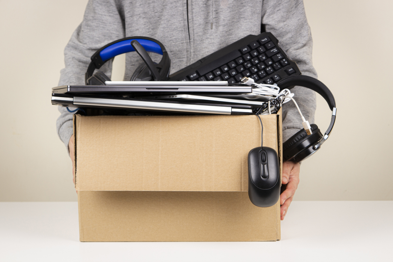 iStock-1437032933 craigslist alternatives Woman hands holding cardboard box full old used computers, phones, tablets, gadget devices for recycling