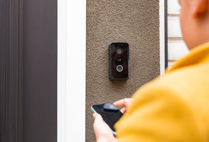 video-doorbell-downsides-person-with-phone-at-doorbell